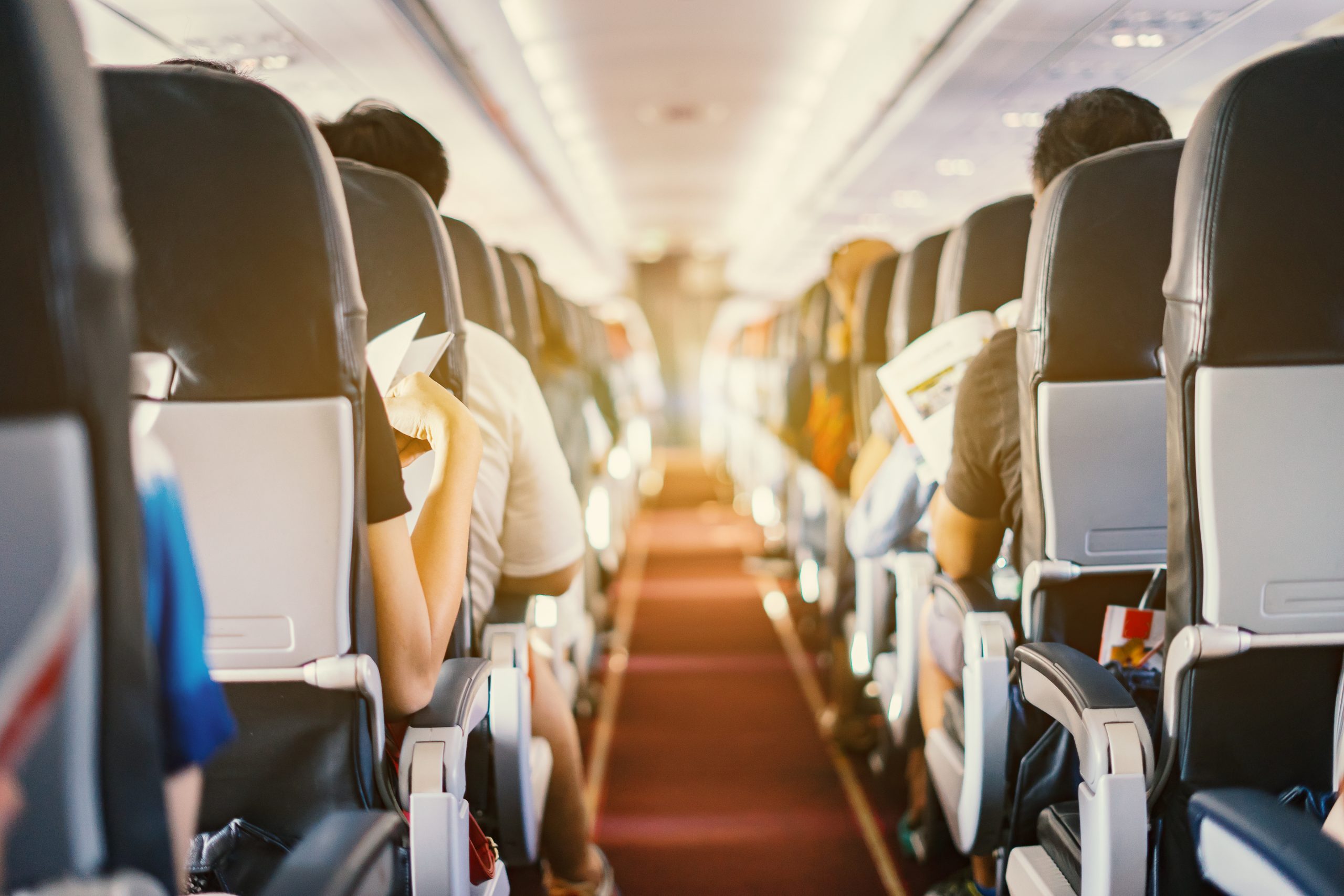 Interior of airplane with passengers sitting